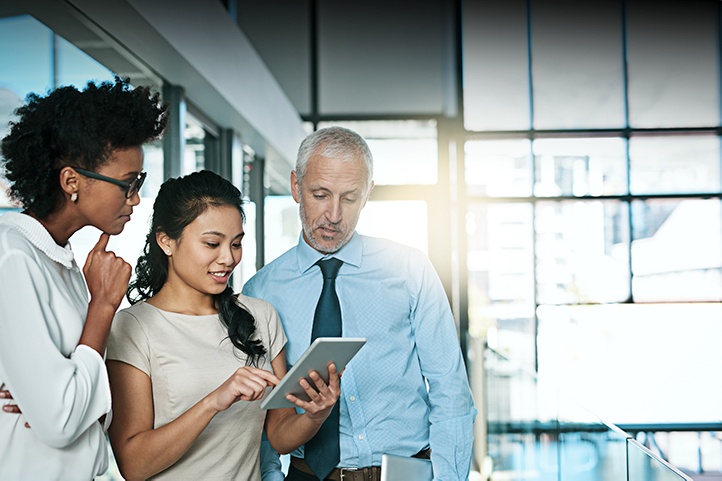 People looking at a tablet in an office